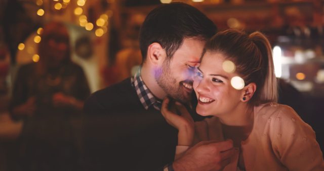 Couple dating at night in pub Romantic couple dating at night in pub